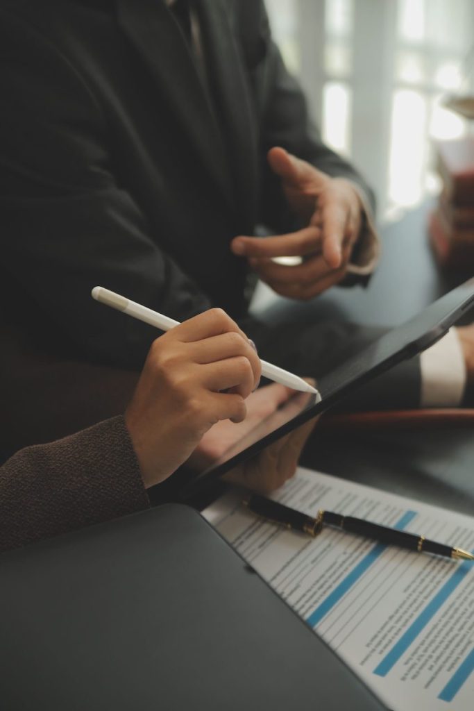 business-lawyers-discussing-contract-papers-with-brass-scale-desk-office-law-legal-services-advice-justice-law-concept-picture-with-film-grain-effect